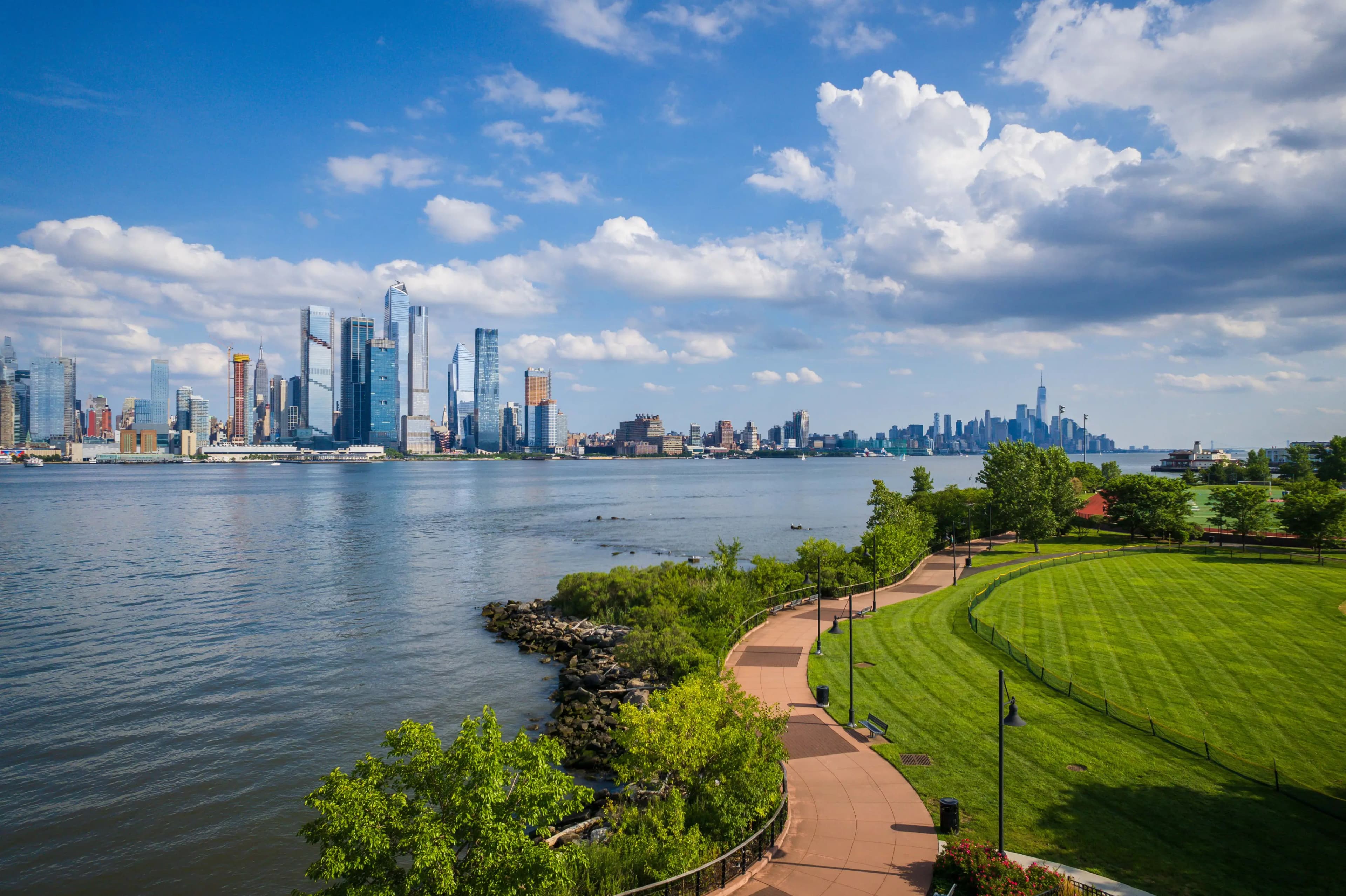 Skyline views, riverfront promenades, and seamless ferry acess placing Manhattan within easy reach.
